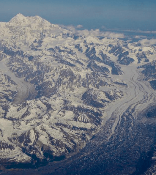 Denali, at 20,310 feet the highest mountain in North America, rises in central Alaska as seen from an airline flight from Fairbanks to Anchorage. Photo by Ned Rozell.