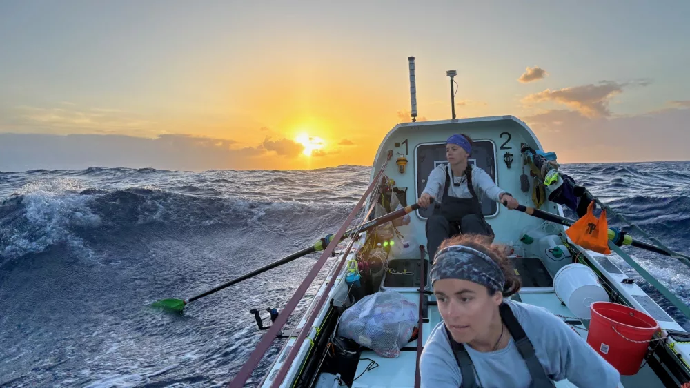 Lauren Shea, foreground, and Noelle Helder row into the sunset as they cross the Atlantic Ocean as part of a four-woman team. Photo courtesy Noelle Helder.