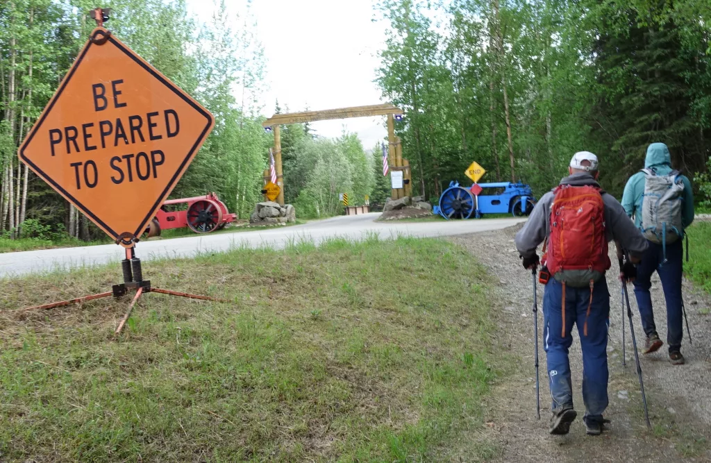 Bruno Grunau, left, and Forest Wagner approach the entryway to Chena Hot Springs Resort and the conclusion of their 50-mile, 33-hour foot journey from Eagle Summit. Photo by Ned Rozell.