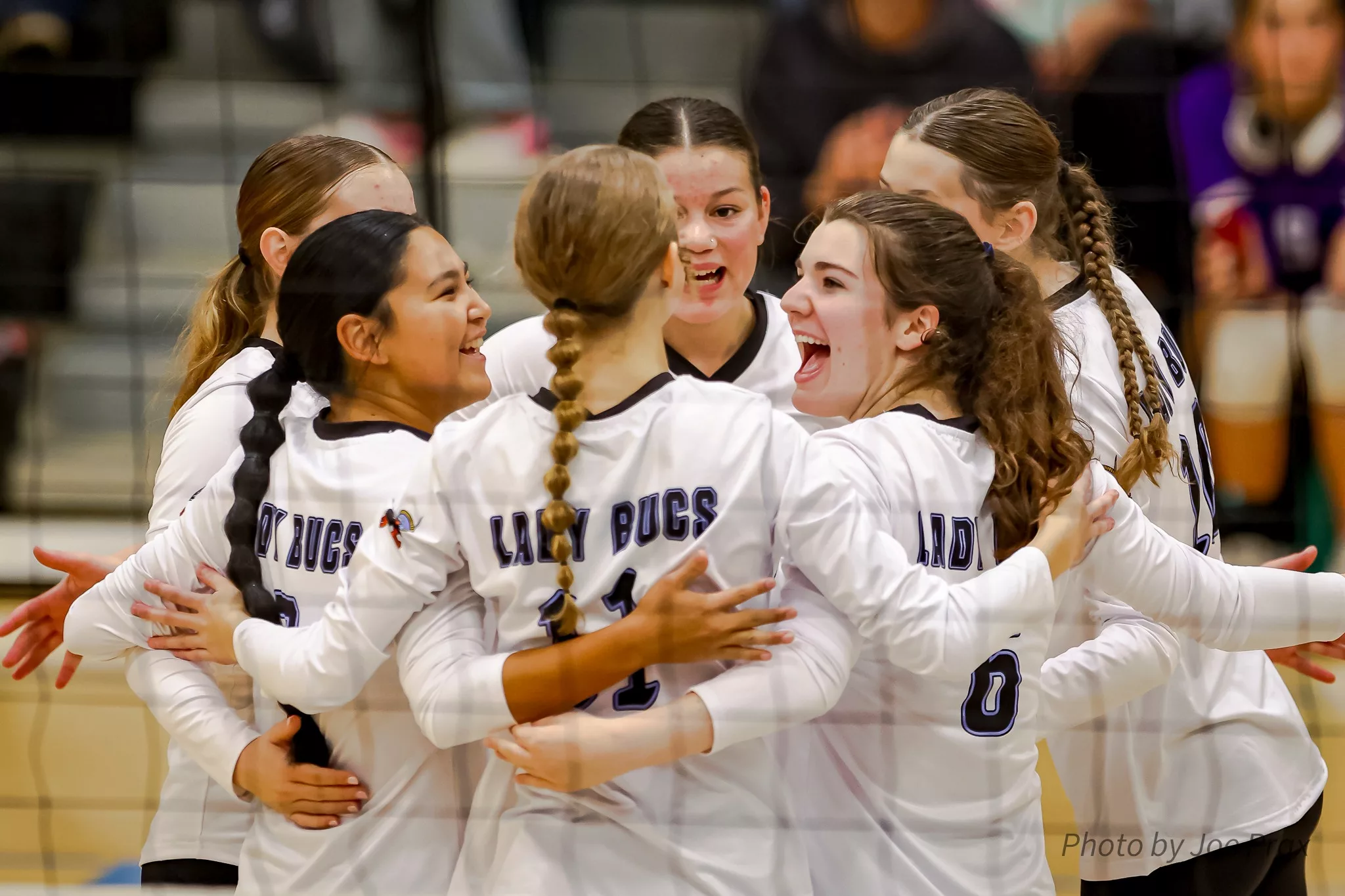 VHS Volleyball team cheering at the game