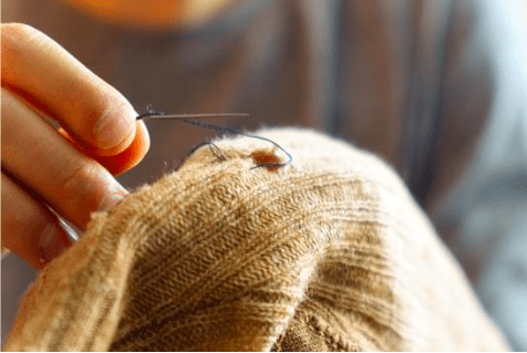 Mending clothes, needle and thread