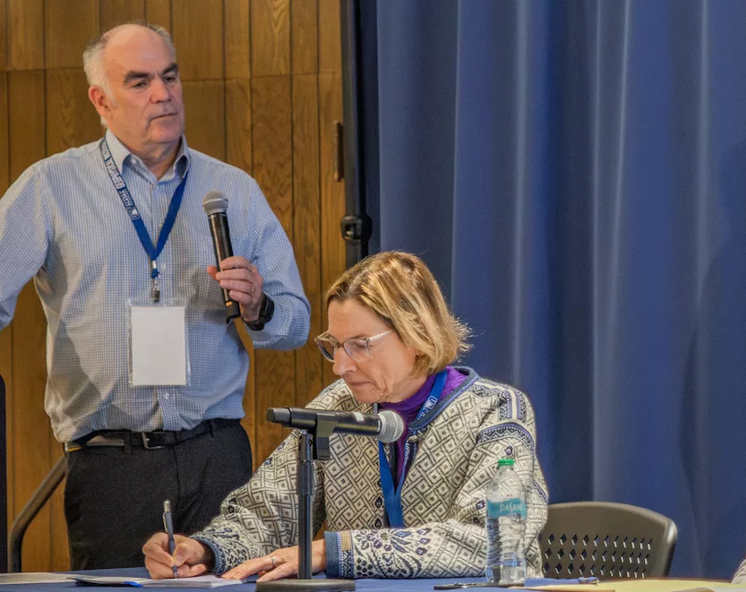 Mark Myers, head of the U.S. Arctic Research Commission, leads a discussion on the potential of geologic hydrogen at a conference in Fairbanks recently. Alaska State Senator Cathy Giessel takes notes. Photo by Eric Marshall.