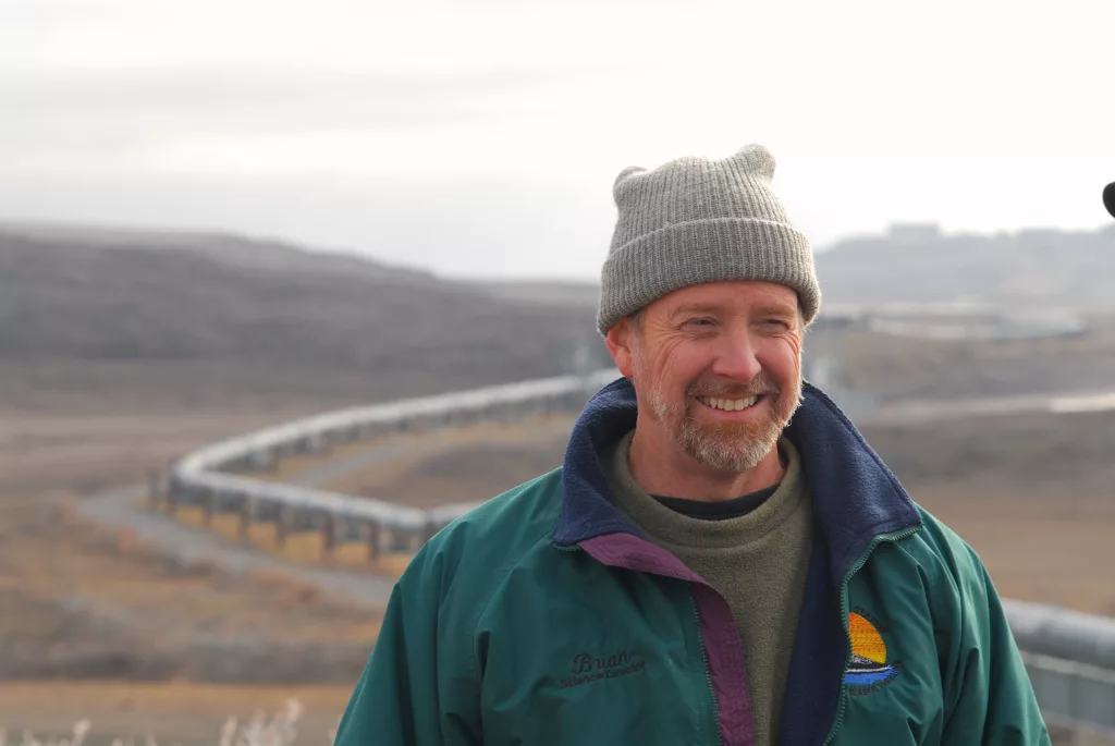 Brian Barnes listens to a colleague while studying ground squirrels near the trans-Alaska pipeline north of the Brooks Range on Sept. 21, 2007. Photo by Øivind Tøien.