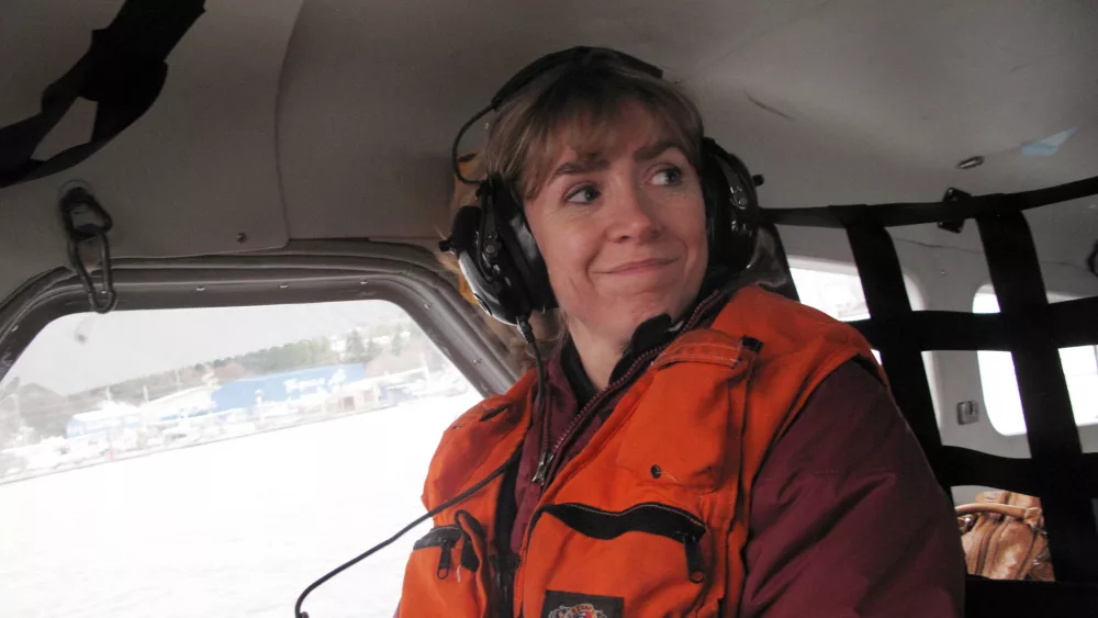 Seismologist Natalia Ruppert smiles from within the cockpit of an amphibious aircraft during a 2013 trip to Sitka and Craig following a large earthquake in the area. Photo by Ned Rozell.