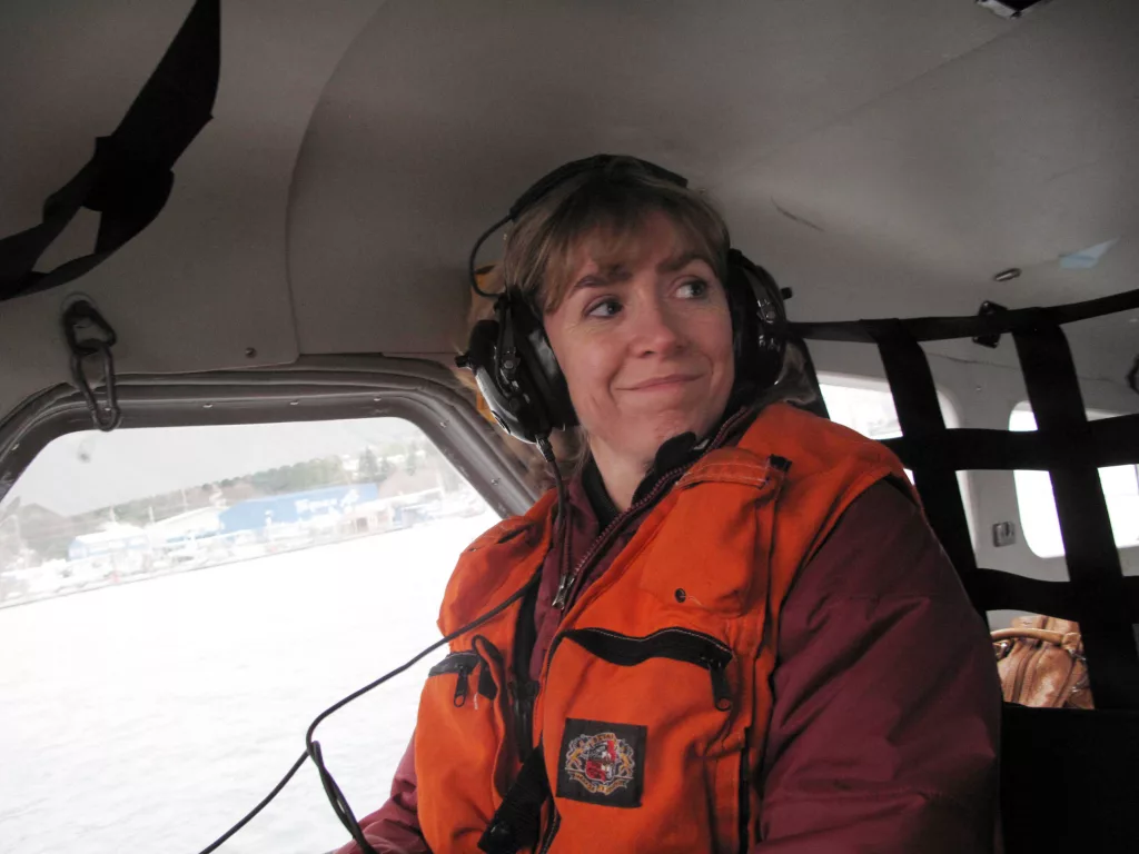 Seismologist Natalia Ruppert smiles from within the cockpit of an amphibious aircraft during a 2013 trip to Sitka and Craig following a large earthquake in the area. Photo by Ned Rozell.