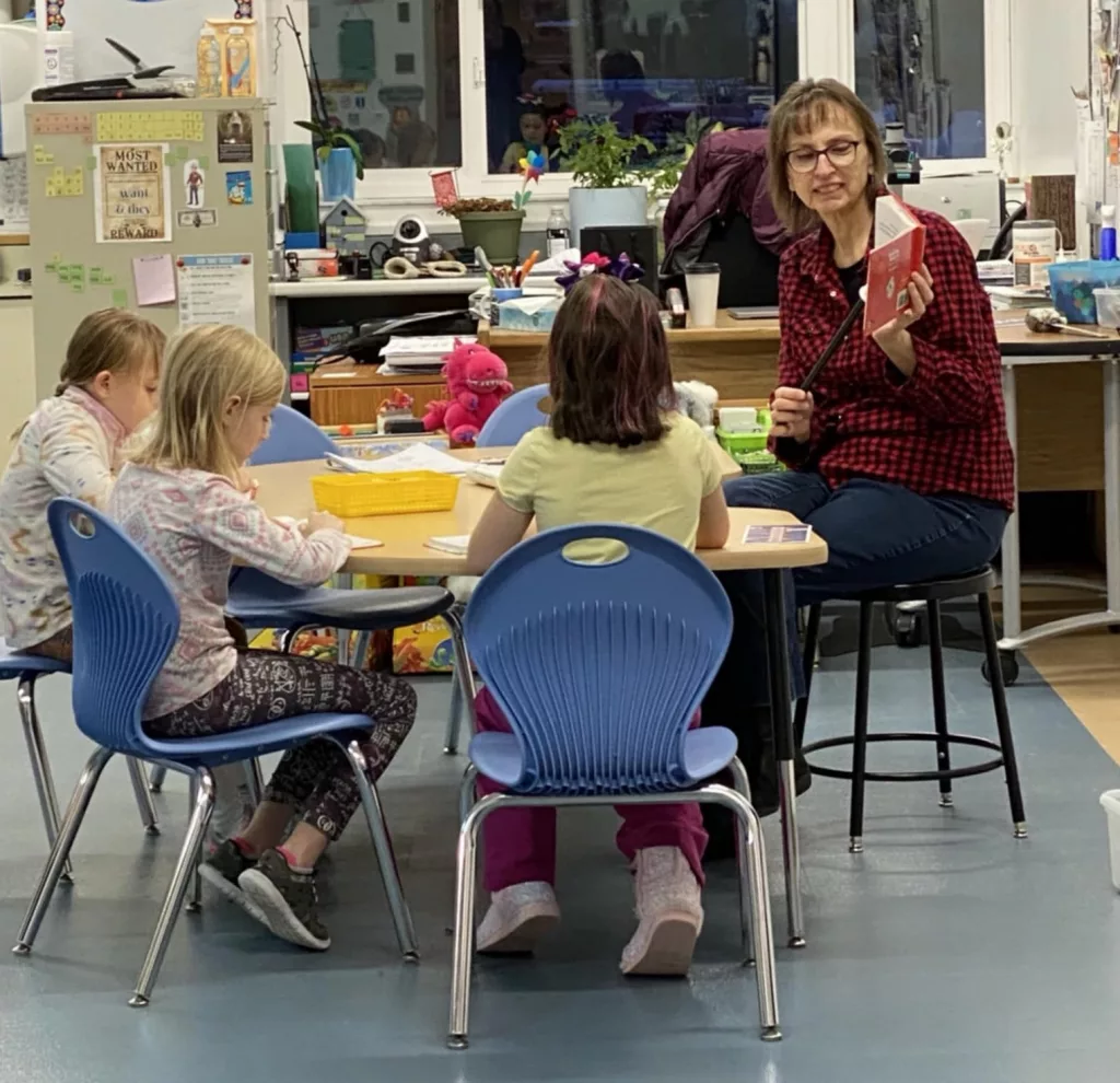 Beverly Colapietro working with students in a classroom