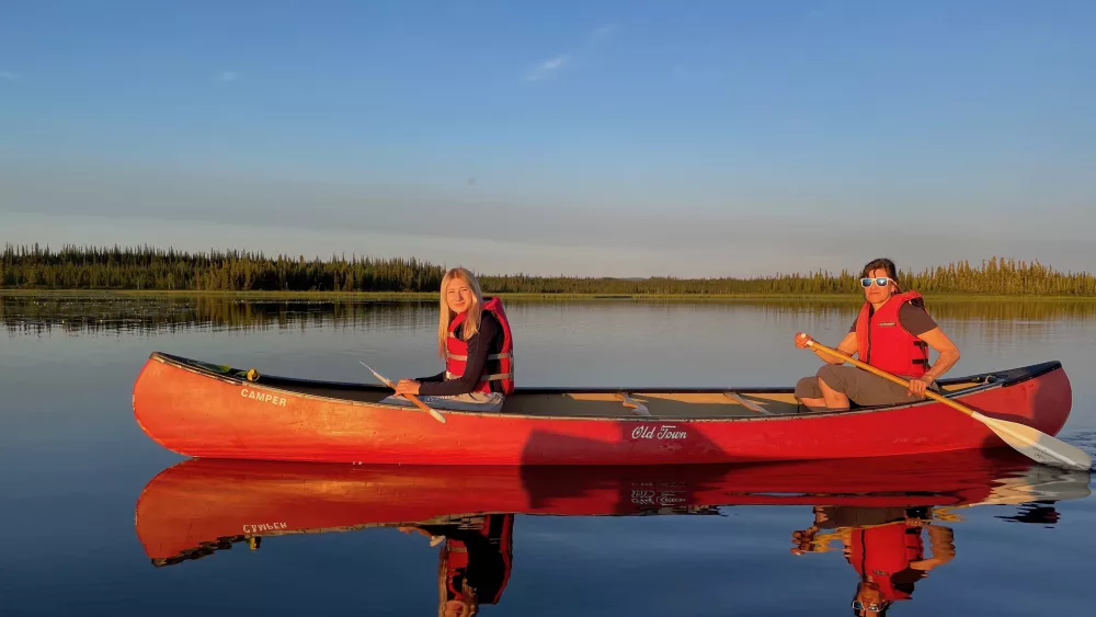 5. From left, Anna and Kristen Rozell canoe upon Deadman Lake in July 2023. Deadman Lake is part of the 934,513 acres of Tetlin National Wildlife Refuge, established in 1980 as part of the Alaska National Interest Lands Conservation Act. Photo by Ned Rozell.