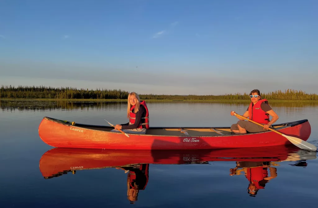 5. From left, Anna and Kristen Rozell canoe upon Deadman Lake in July 2023. Deadman Lake is part of the 934,513 acres of Tetlin National Wildlife Refuge, established in 1980 as part of the Alaska National Interest Lands Conservation Act. Photo by Ned Rozell.