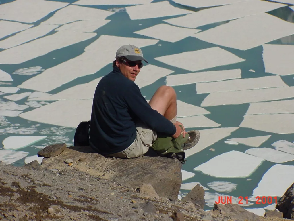 Ned Rozell sits at the edge of the volcanic crater on Mount Katmai during a trip to the Valley of 10,000 Smokes in 2001. Photo by John Eichelberger.