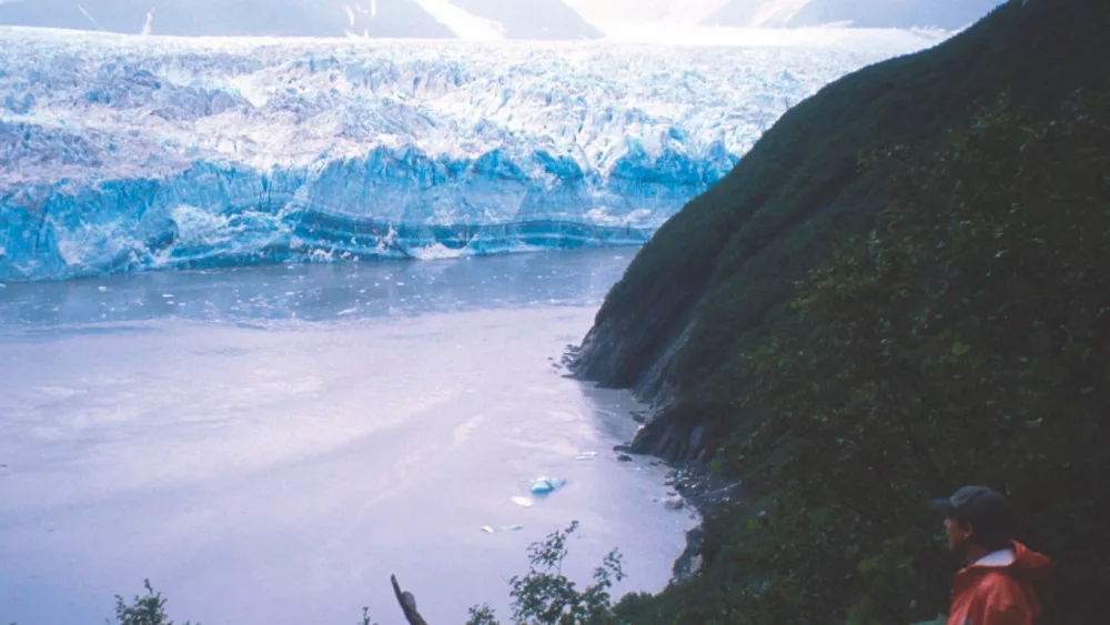 Ned Rozell watches the advance of Hubbard Glacier as it advances on Gilbert Point in 2002. Photo by Martin Truffer.