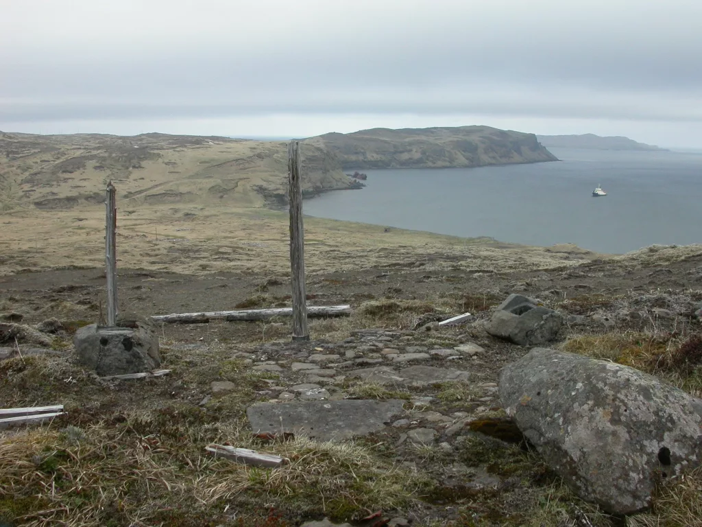 A Shinto shrine remains on Kiska Island after a brief Japanese occupation during World War II. The Alaska Maritime National Wildlife Refuge’s ship, the Tiglax, floats in the background. Photo by Ned Rozell.