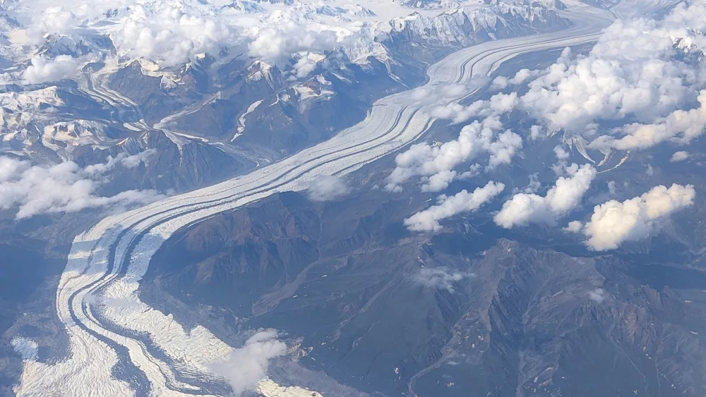 The Klutlan Glacier flows into the Yukon from Alaska’s Mount Bona, the highest peak in the photo, and Mount Churchill, the high ridge to the right of Bona. Image courtesy the Alaska Volcano Observatory/Alaska Division of Geological and Geophysical Surveys.