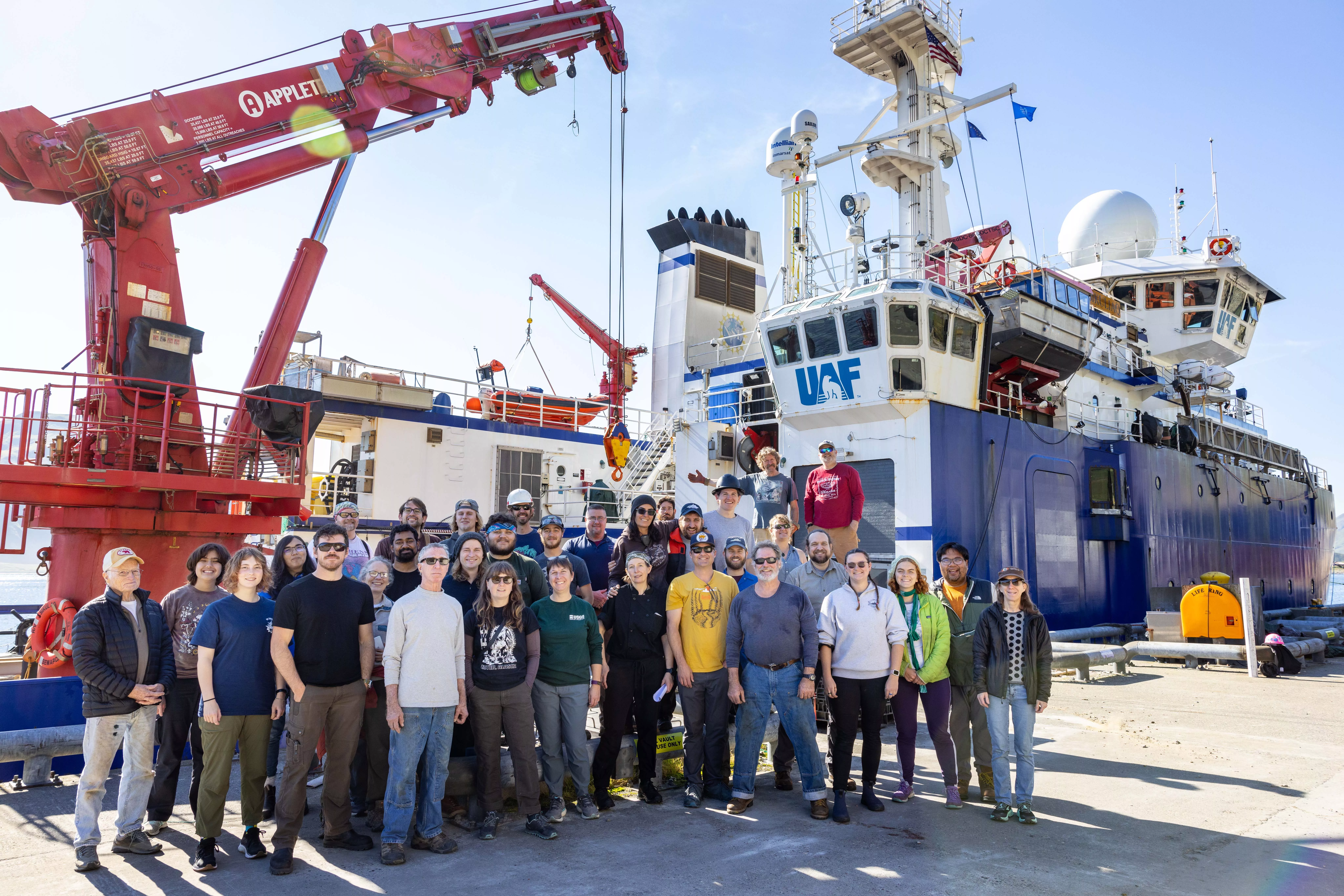 Researchers and crew members pose beside the University of Alaska Fairbanks research ship Sikuliaq in Dutch Harbor during a 2023 cruise to the Bering Sea to learn more about the Bering Land Bridge. Photo by JR Ancheta.