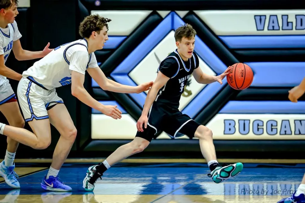 Jarrett Gage dribbles the ball against Hutchison, VHS Basketball February 2025