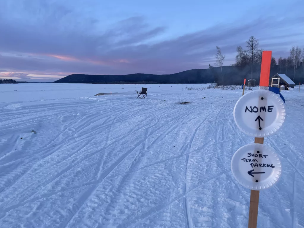 Signs in front of Tolovana Roadhouse instruct Iditarod mushers which way to go during the 2025 Iditarod sled dog race in early March 2025. Photo by Ned Rozell.