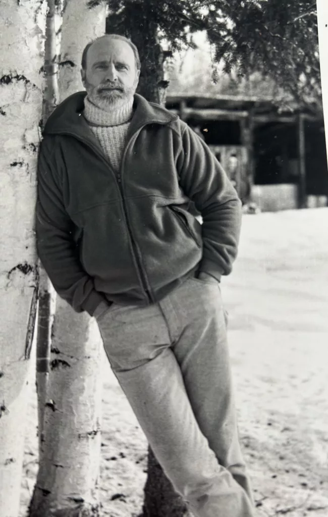 Dale Guthrie leans against a birch tree outside his home in Fairbanks. Photo by Mary Lee Guthrie.