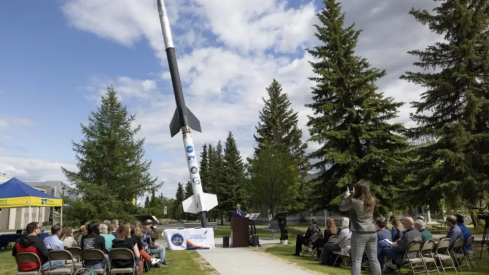 A crowd watches the signing of a memorandum of understanding between the UAF Geophysical Institute and the Alaska Aerospace Corp. UAFGI Photo by Bryan Whitten