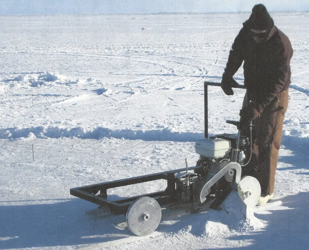 4. Lew Shapiro cuts into sea ice north of Utqiaġvik, then called Barrow, during his long career with the Geophysical Institute. Photo courtesy of UAF Geophysical Institute.
