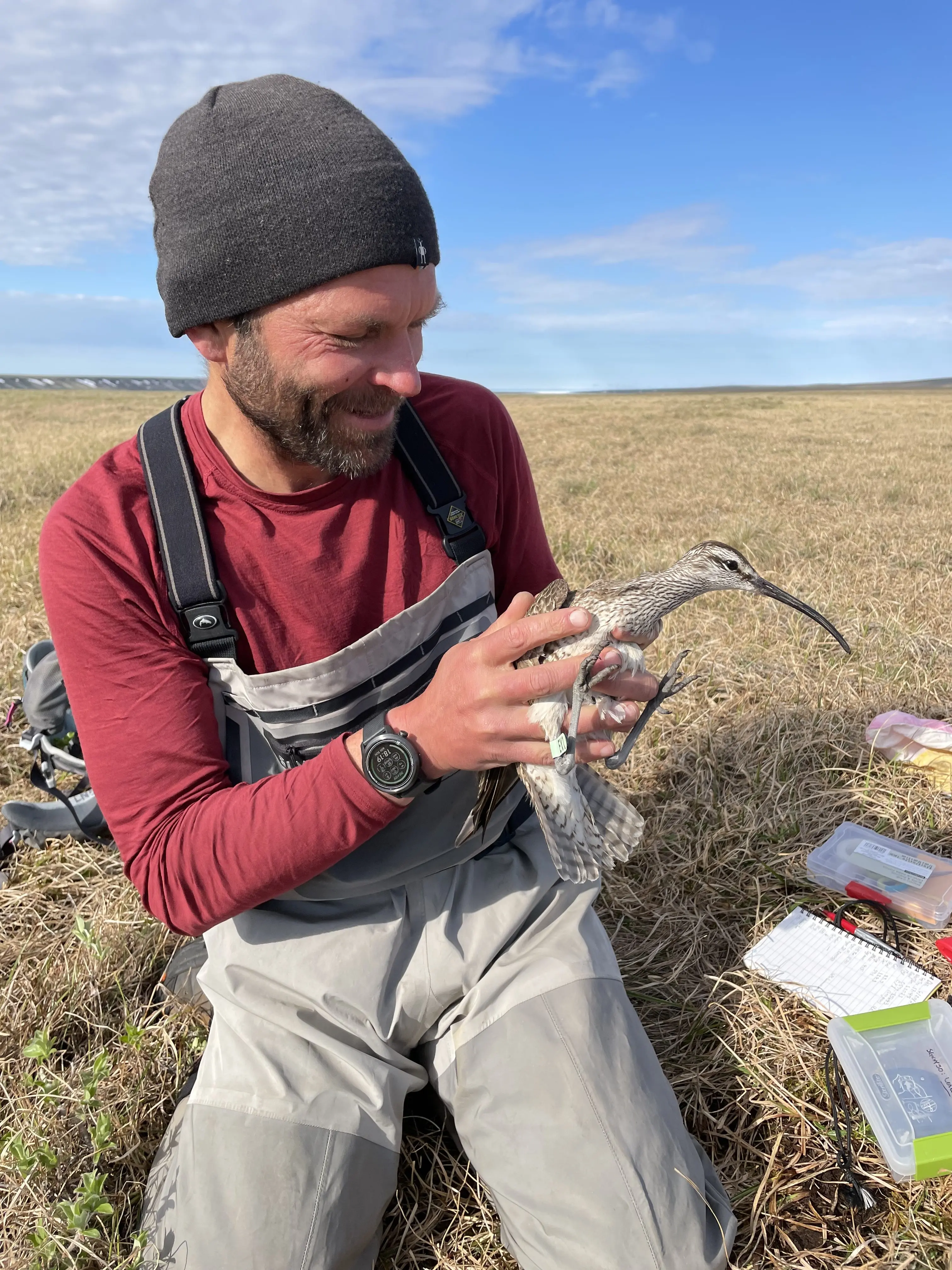 In 2021, the late Shiloh Schulte holds a whimbrel that nested above the Katakturuk River in northern Alaska. Photo by Kirsti Carr.
