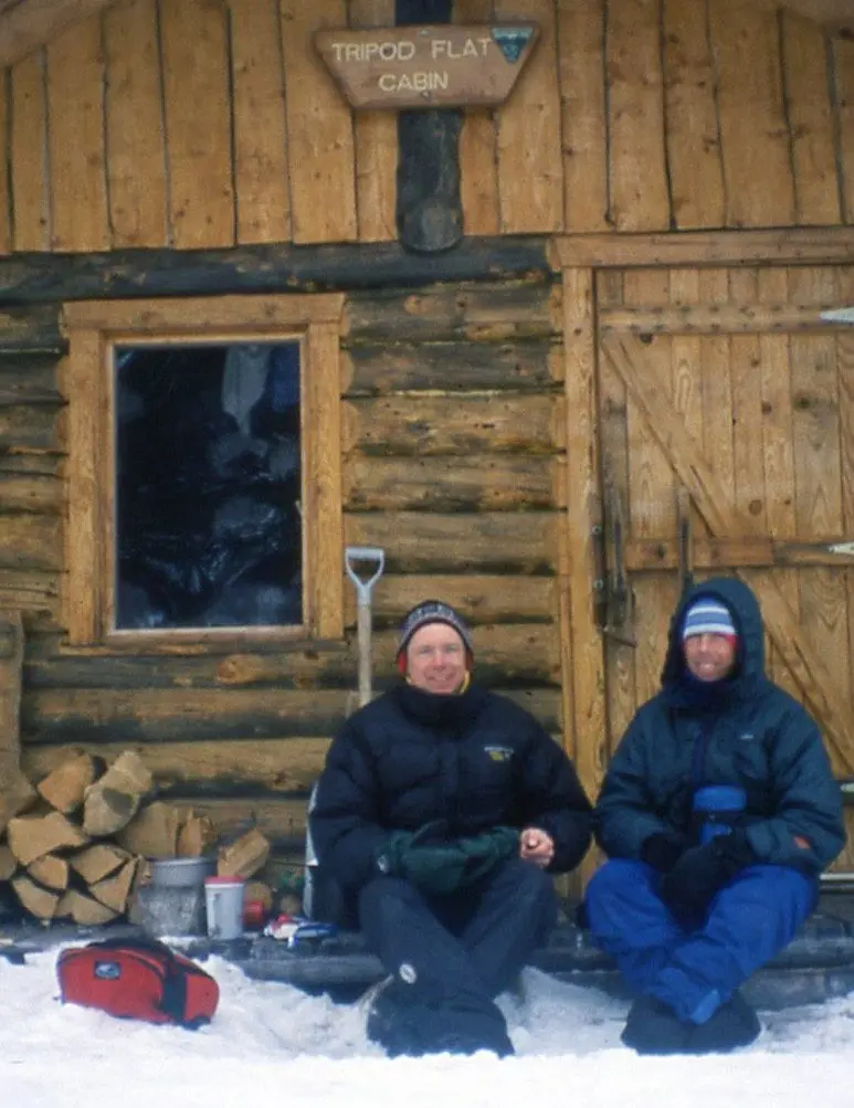 Ned Rozell, left, and Andy Sterns of Fairbanks have dinner outside Tripod Flat cabin between Kaltag and Unalakleet in March 2001. Photo by Ned Rozell.