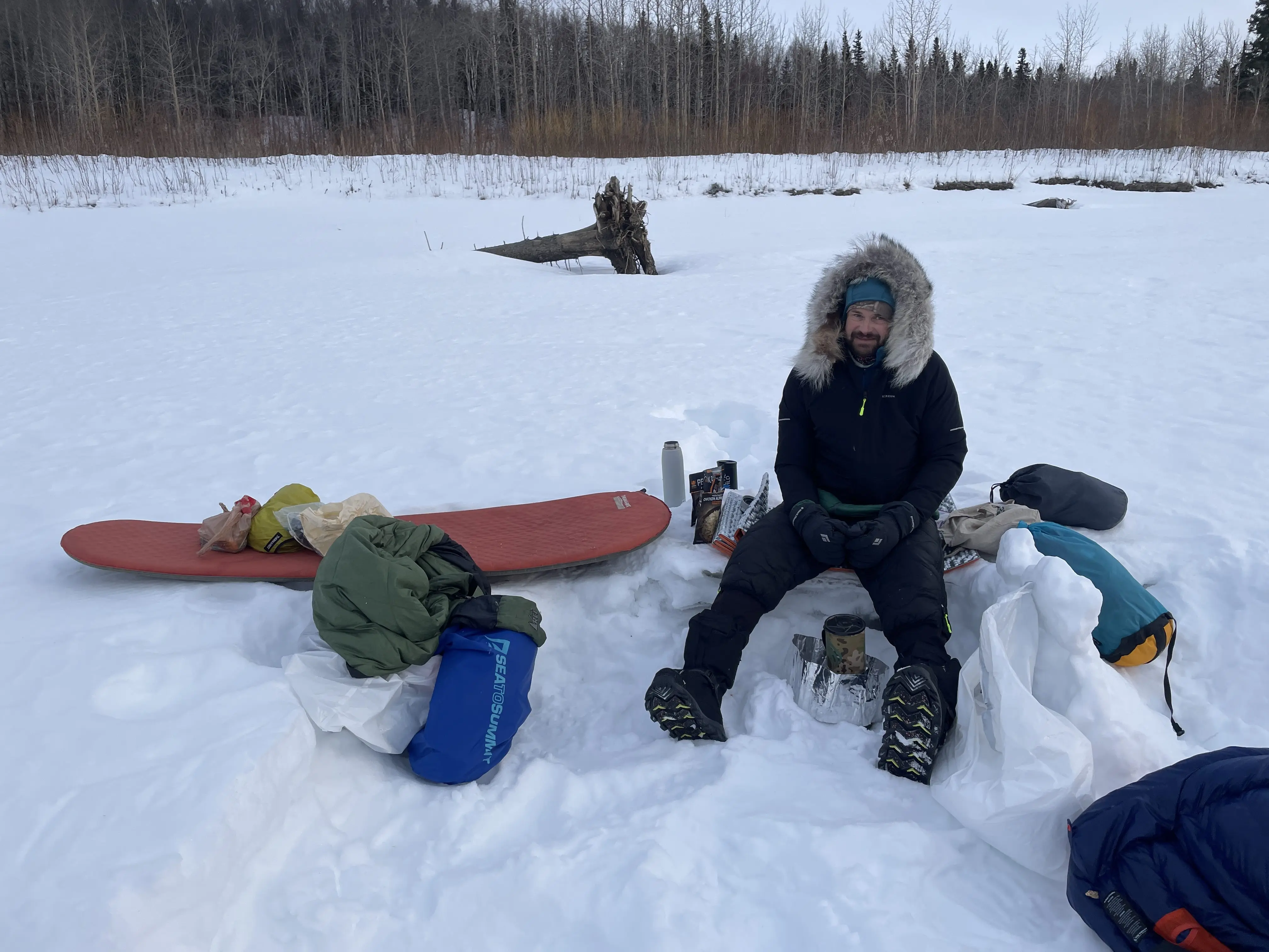 Forest Wagner melts snow to hydrate meals at a campsite on the Yukon River between the villages of Ruby and Tanana. Photo by Ned Rozell.