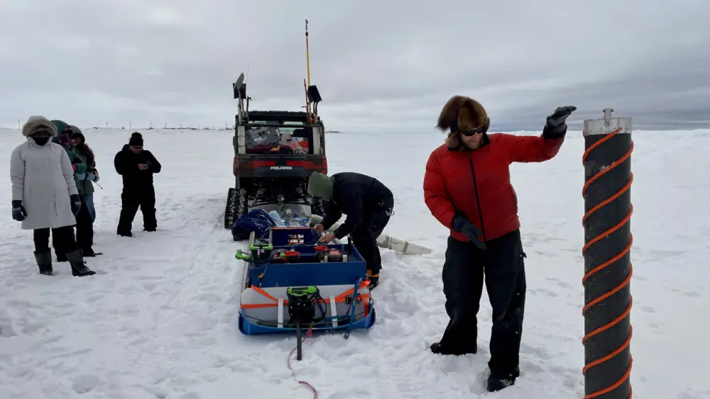 University of Alaska Fairbanks postdoc Marc Oggier shows off his custom-made, extra-large ice auger during a sea ice tour, part of the Arctic ACTION Workshop that recently took place in Utqiaġvik, Alaska. Photo by Sara Wilbur.