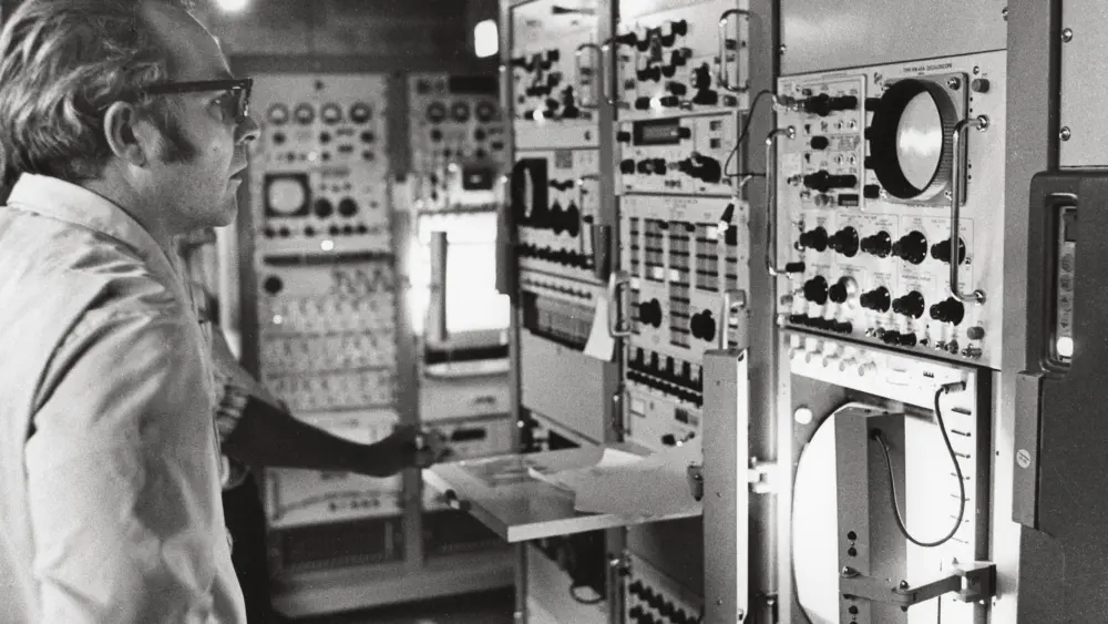 Column author T. Neil Davis, former deputy director of the Geophysical Institute, observes data acquisition in the Poker Flat Research Range blockhouse during a rocket flight in the early 1970s. Photo courtesy of the Geophysical Institute