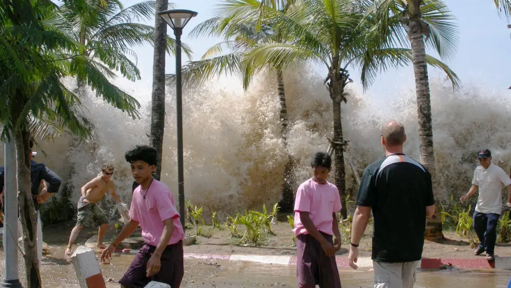 A tsunami surges into a coastal Thai village on Dec. 26, 2004. Photo by David Rydevik
