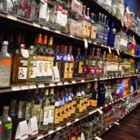 Shelves display bottles of liquors^ and wines.