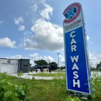 A new Champion Xpress car wash at 1819 N. Henderson St. is now scheduled to open in “mid September.”