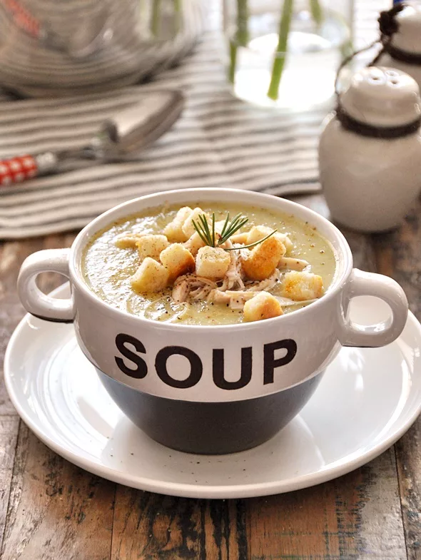 bowl of vegetable soup with the word SOUP written in all capital letters