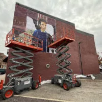 Artist Angie Smith and her assistant Adam Smith work on a 20 by 32 foot mural depicting Abraham Lincoln and his 1858 appearance at Knox College for the Lincoln-Douglas Debate on Monday on the north wall Masa Sushi & Hibachi^ 58 S. Cherry St.