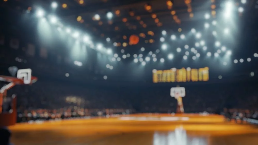 Blurred background of intimate atmosphere of a basketball arena during a crucial playoff game^ filled with excitement^ energy^ and passionate fans enjoying every moment.
