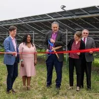 Galesburg Mayor Peter Schwartzman^ center^ cuts the as Nexamp and Trajectory Energy Partners celebrated the opening of Blue Grama Solar^ a 4.7 megawatt community solar farm on Thursday^ June 12^ 2025^ at 1489 S. Farnham St. in Galesburg. Other Galesburg representatives pictures are Pam Gaither with the Galesburg Area Chamber of Commerce and John Schlaf with Knox County Area Partnership. (PHOTO COURTESY NEXAMP)