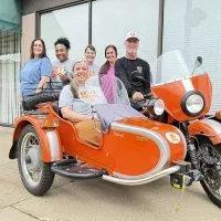 The Orange Cup Family^ clockwise from left: Alyssa Sloan^ LaToya Carson^ Melany Baldwin^ Amanda Bauchman^ Scott Baldwin and Sarah Baldwin.
