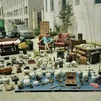 Huang Qingjun’s project^ “Family Stuff^” spans more than 20 years and includes 150 photographs. In it^ he gathers a family’s belongings from different spaces in their home and arranges them in one place to take a photograph with the family members. (Courtesy of Huang Qingjun)