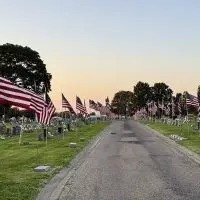 Flags line the route to the grave site of Cpl. Paul Hoots at East Linwood Cemetery in Galesburg.