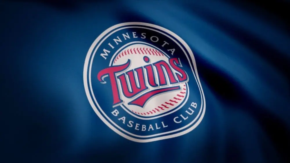 Close-up of waving flag with Minnesota Twins MLB baseball team logo^ seamless loop. Editorial footage