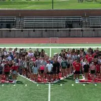 Large group photo of Monmouth College’s fall 2025 incoming class (265 students) on the football field – the college’s biggest freshman/transfer class in ten years.