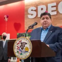 Gov. JB Pritzker speaks at a Springfield grocery store in 2022 in favor of temporarily eliminating the state’s grocery tax. Four years later^ the tax will end permanently^ at least statewide. (Capitol News Illinois file photo by Jerry Nowicki)