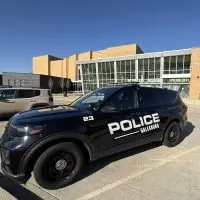 Galesburg Police vehicle parked in front of Galesburg High School entrance during precautionary increased presence