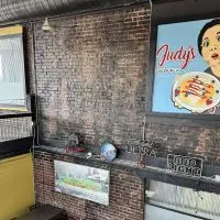 Interior view of Judy's Kitchen in downtown Galesburg^ highlighting the seating area beneath the mural that will be converted into a new open kitchen for breakfast production.