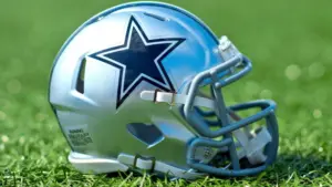 NFL Dallas Cowboys helmet on artificial grass playing turf ^ product shot