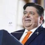FILE - Illinois Gov. J.B. Pritzker addresses the crowd on June 28^ 2023^ at the Old Post Office in Chicago. Members of a legislative review panel agree that Gov. J.B. Pritzker's proposal to replace Logan and Stateville prisons makes senses^ but they said Friday^ June 14^ 2024^ that the administration needs to provide more details. (AP Photo/Evan Vucci^ File)