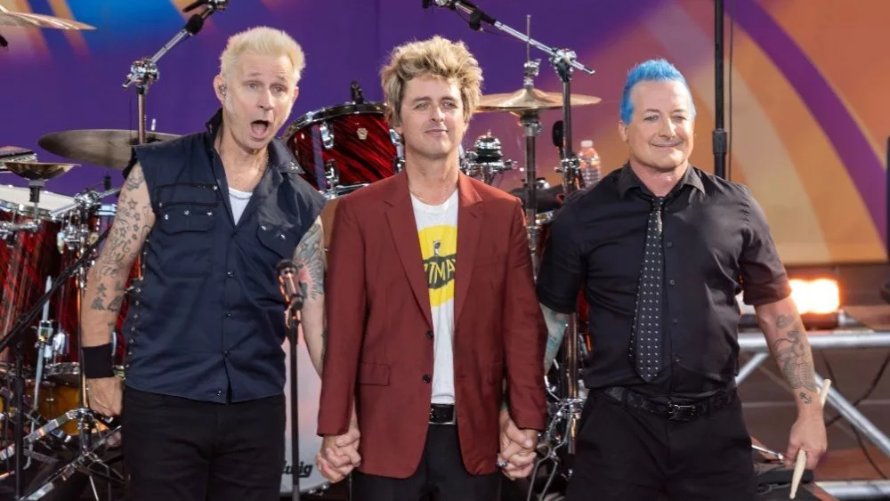 Mike Dirnt^ Billie Joe Armstrong^ Tre Cool pose on stage during ABC Good Morning America rock group Green Day concert in Central Park in New York on July 26^ 2024