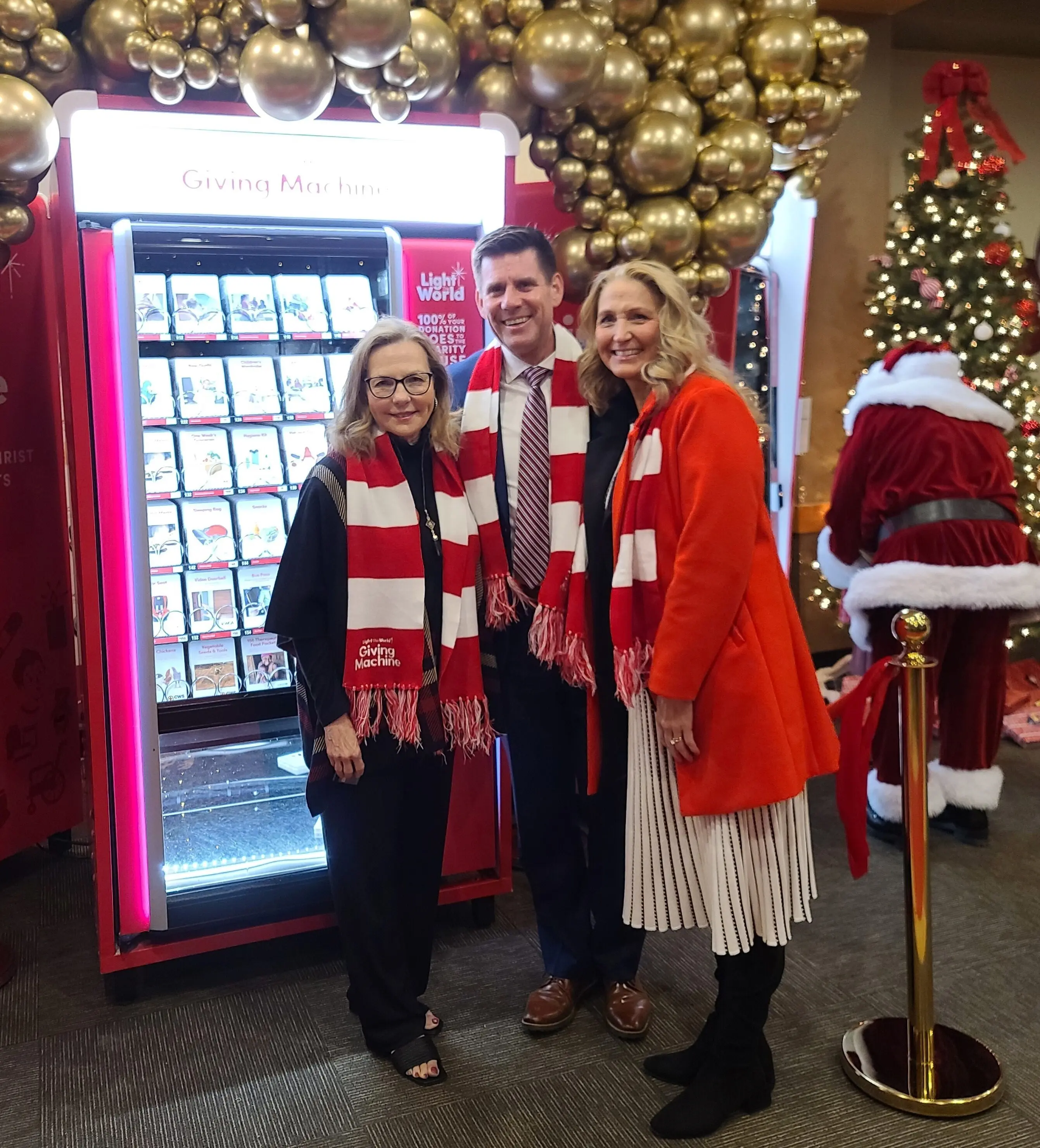 suzanne-pillen-elder-rodney-ames-kimberlee-ames-in-front-giving-machine