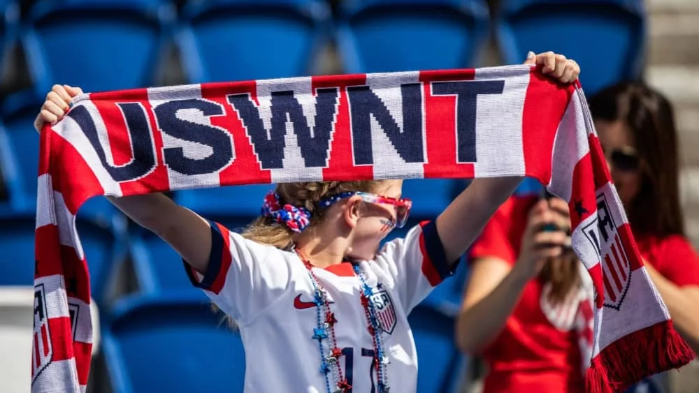 A fan holds USWNT scarf before the 2019 FIFA Women's World Cup match between USA and Chile.
