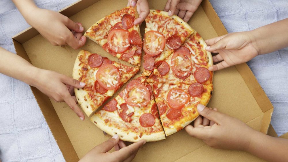 childrens-hands-taking-pizza-slices-out-or-high-res-stock-photography-591394853-1548187732558013