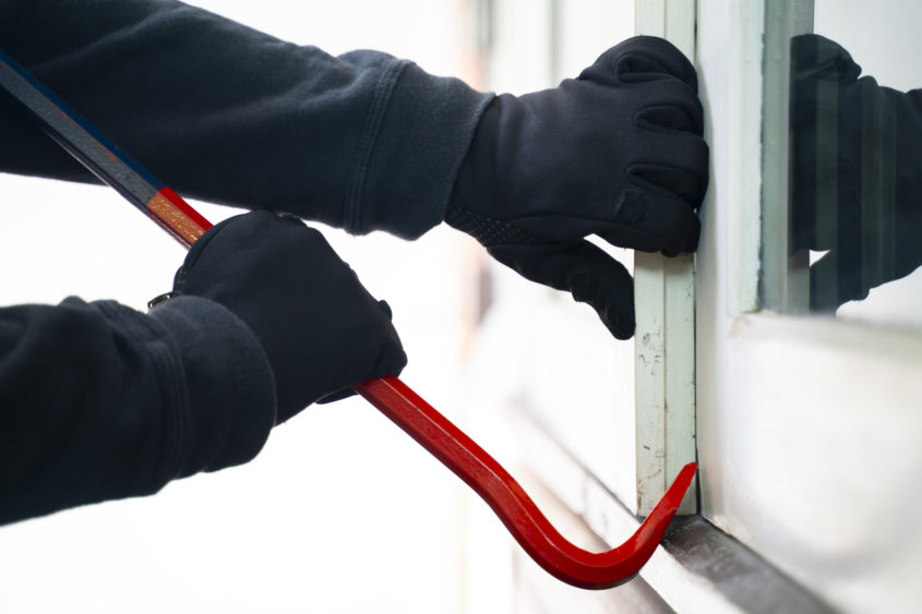 burglar-trying-to-break-into-a-house-with-a-crowbar