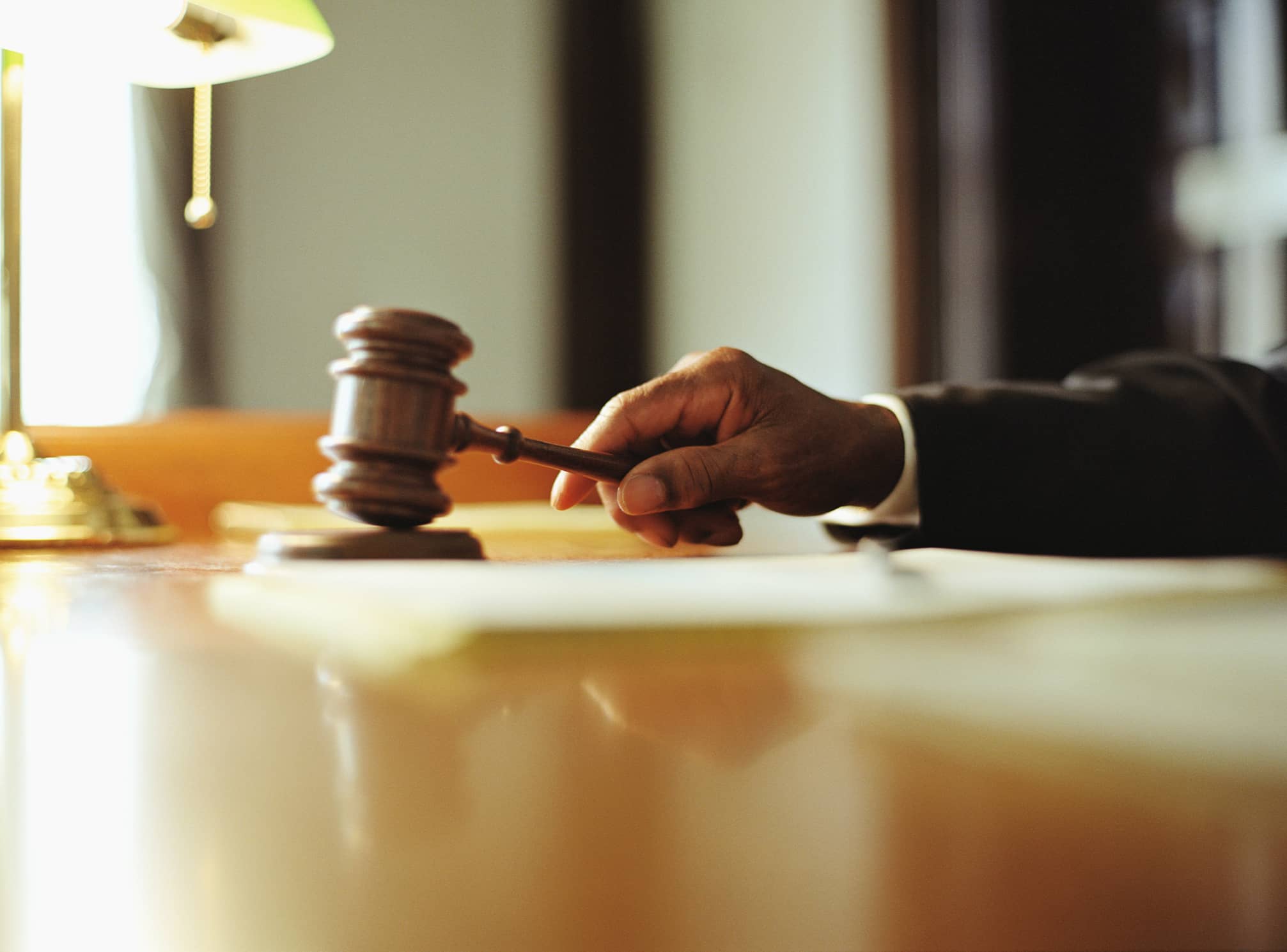 male-judge-striking-gavel-in-courtroom-close-up